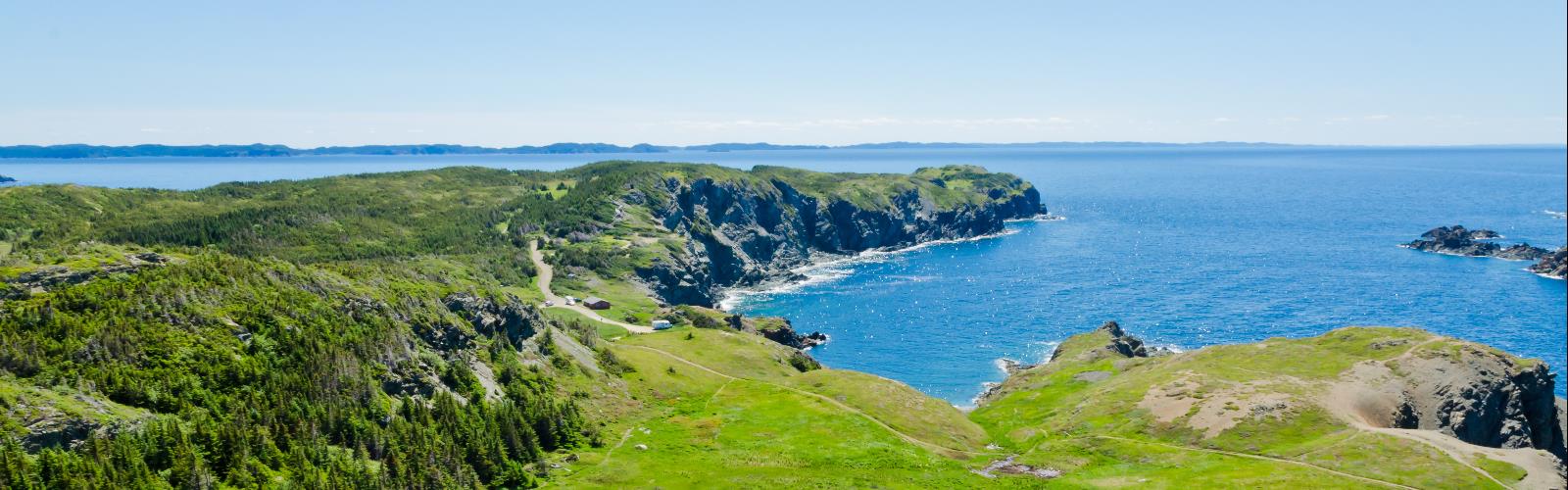 Hiking in Newfoundland - natural landscape  sky outdoor water beach grass mountain nature landscape hill lake hillside green ocean cape overlooking promontory lush land