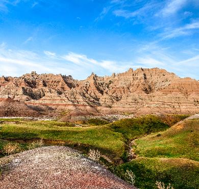 South Dakota  mountain rock valley outdoor grass canyon sky nature landscape cloud desert rocky badlands escarpment outcrop plant wadi hillside stone