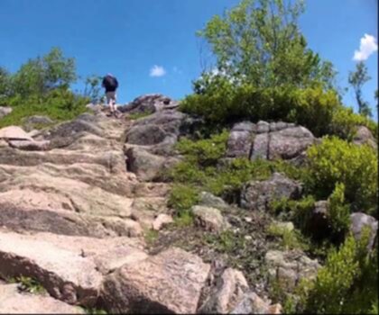 Gorham Mountain, Maine trail - hiking in Down East & Acadia  outdoor rock hiking sky mountain person rocky standing footwear nature hiking equipment clothing hillside