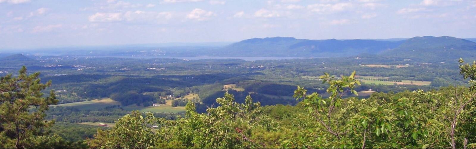 Hiking Schunnemunk Mountain, New York - panoramic view  mountain outdoor sky nature landscape hill cloud tree plant field hillside green overlooking lake lush land highland